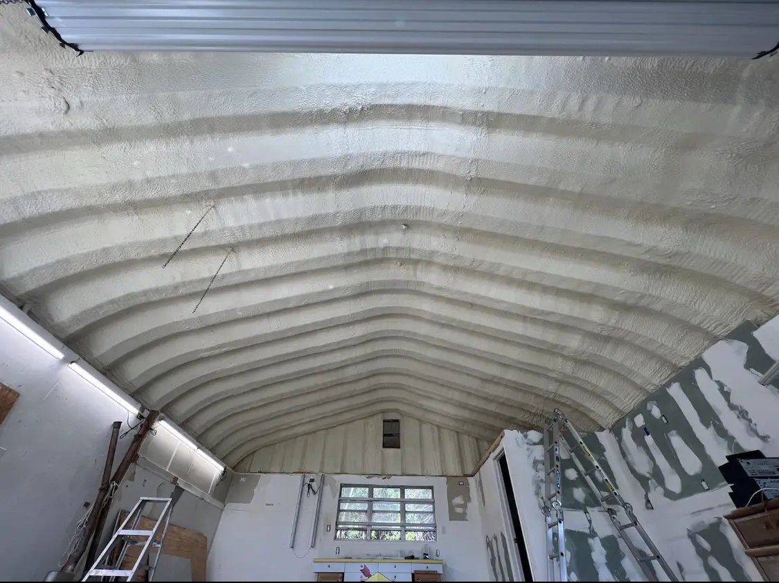 Spray polyurethane foam applied to the underside of a metal roof deck in Erie